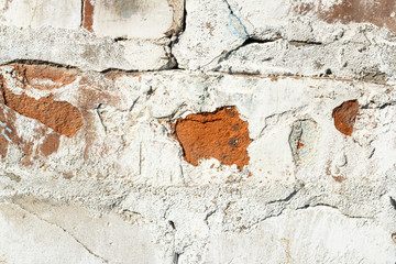 Crack on old white brick wall close-up