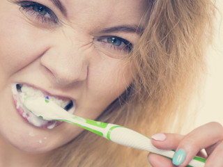 Woman brushing cleaning teeth