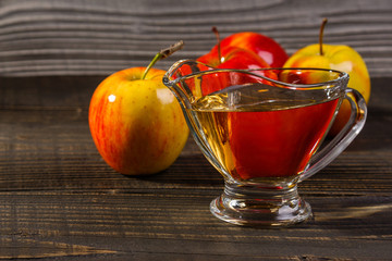 apple vinegar on a wooden rustic background