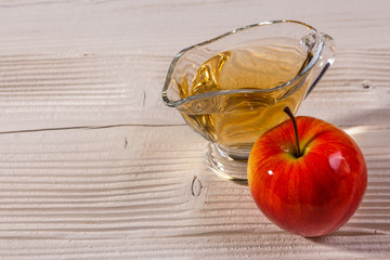 apple vinegar on a wooden rustic background