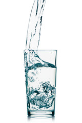The stream of water pouring into a glass