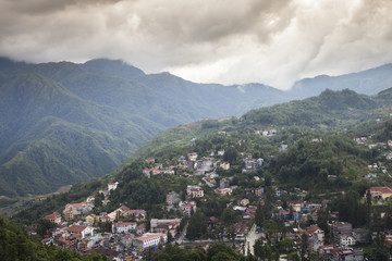 Fototapeta na wymiar View of village from top of mountain with mountain background located at sapa Vietnam