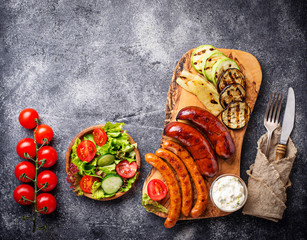 Assortment of grilled sausages and vegetables