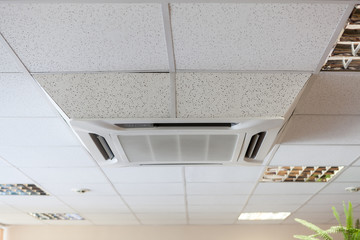 Suspended tile ceiling with high-capacity air conditioner unit, an office room