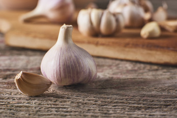 Fresh garlic bulbs and cloves on cutting board