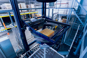 Strapping machine for packaging line. Modern machine for packaging line in factory. Technology and...
