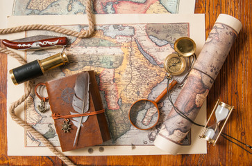 Planning a trip: quill pen, old papers and maps with vintage items