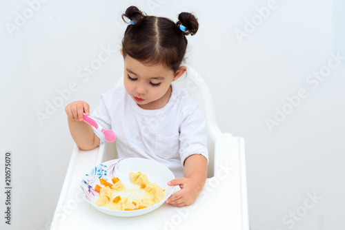 Independent Adorable Girl With Funny Pigtails Eat Soup With