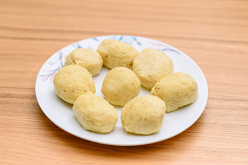 Traditional matzoh ball (kneidlach) for soup.White platel with authentic matzo ball for chicken taste hot soup ( bouillon ) tradition Jewish food for Passover and every day.