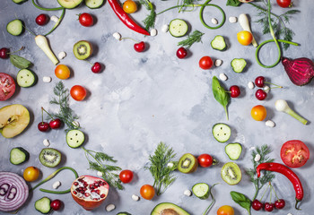 Flat lay fresh vegetables, fruits and herbs on concrete background. Top view