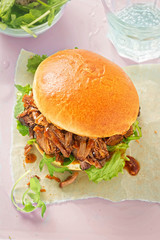 Pulled pork bun with lettuce and barbecue sauce