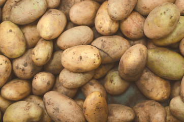 Raw potatoes textre background, top view.