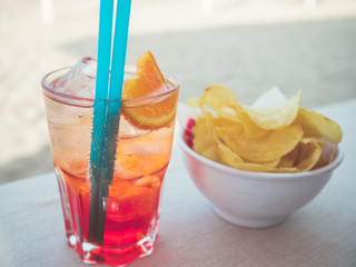spritz cocktail and chips