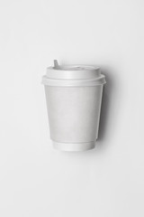 Empty white disposable paper cup with plastic lid isolated. Empty polystyrene coffee drinking mug mock-up front view.