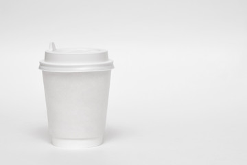 Empty white disposable paper cup with plastic lid isolated. Empty polystyrene coffee drinking mug mock-up front view.