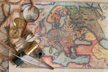 Planning a trip: quill pen, old papers and maps with vintage items