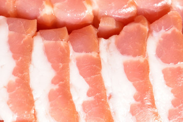 Beautiful sliced bacon. Sliced bacon smoothly laid close-up