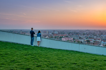 Fototapeta premium Couple wathing the sunset in Oradea from Mushroom Hill in Romania