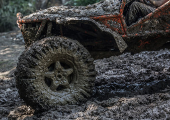 Fototapeta na wymiar Detail of buggy stuck in mud outdoor