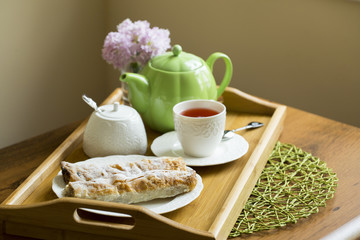 Afternoon tea concept: Cup of herbal linden tea, apple pie on white background. Flat lay