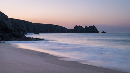 Stunning vibrant sunrise landscape image of Porthcurno beach on South Cornwall coast in England