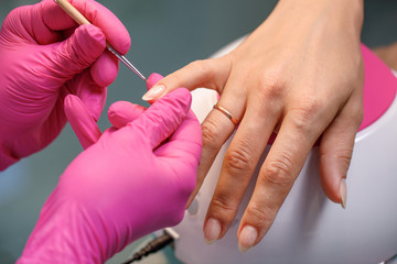 beautician applying Polish nails