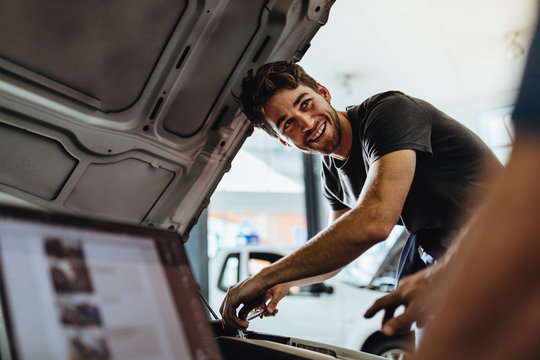 Car mechanics working at auto repair shop