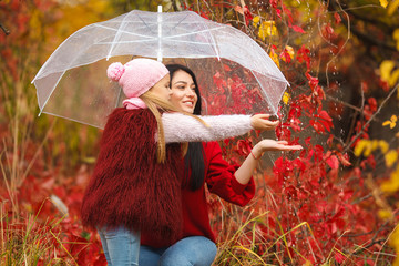 Happy girls on bright autumn background having fun together.