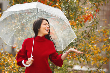 Cheerful young woman with umbrella