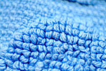 Macro of light blue terry cloth texture of a towel. Selected focus.