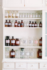 Fototapeta na wymiar Shelves with bottles of drugs in ancient drugstore
