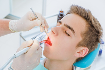 Kid boy in dentist's chair the office treats teeth.