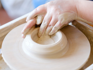 pottery handcraft hobby. hands forming and shaping clay on potter wheel
