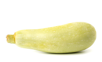 One ripe zucchini on a white, close-up.