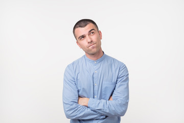 Let me think or oubt concept. Young hispanic man is very serious and pensive