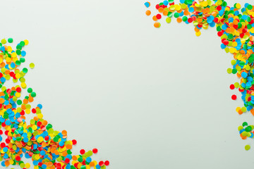 Confetti scattered in different colors on a white background. Festive confetti. The decor for the party.