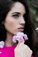 Spring fashion girl outdoors portrait in blooming trees.