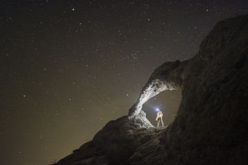 Silhouette of man with flashlight - obrazy, fototapety, plakaty