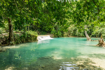 Tad Kwang Si (Xi) the biggest water fall land mark in Luang Prabang, Laos ,beautiful turquoise color water at tropical forest in north Lao, for use as a background or travel advertisement image