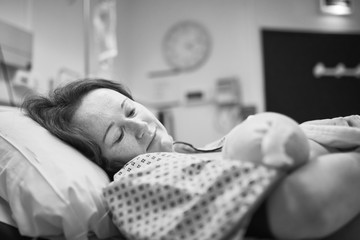 Mother holding her newborn baby right after delivery