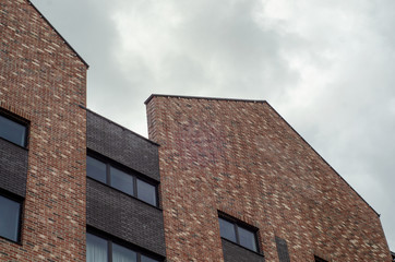 Brick building on the sky clouds background