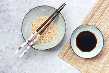Asian style  ceramic  bowl and  chopstick on  gray  background. Top view
