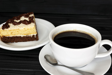 coffee with foam and cake on a dark background