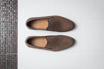 top view of two brown shoes on stylish background;
