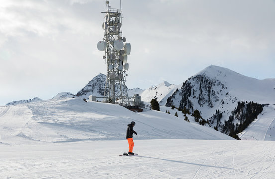 A transmitter at the top of a mountain in the Dolomites ski area. Empty ski slope in winter on a sunny day. Prepare ski slope, Alpe Cermis, Italy