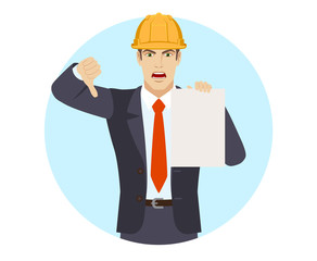 Businessman in construction helmet showing the blank paper and showing thumb down. Gesture as rejection symbol down