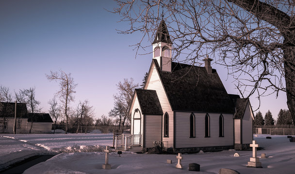 Sunset over historical prairie church in winter