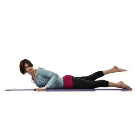 Mother woman exercising doing postnatal workout. Female fitness stretching hands and legs in gym...