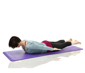 Mother woman exercising doing postnatal workout. Female fitness stretching hands and legs in gym...