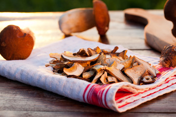 preparing fresh boletus edulis for drying over Wooden Background. Autumn Cep Mushrooms. Cooking delicious organic mushroom. Gourmet food